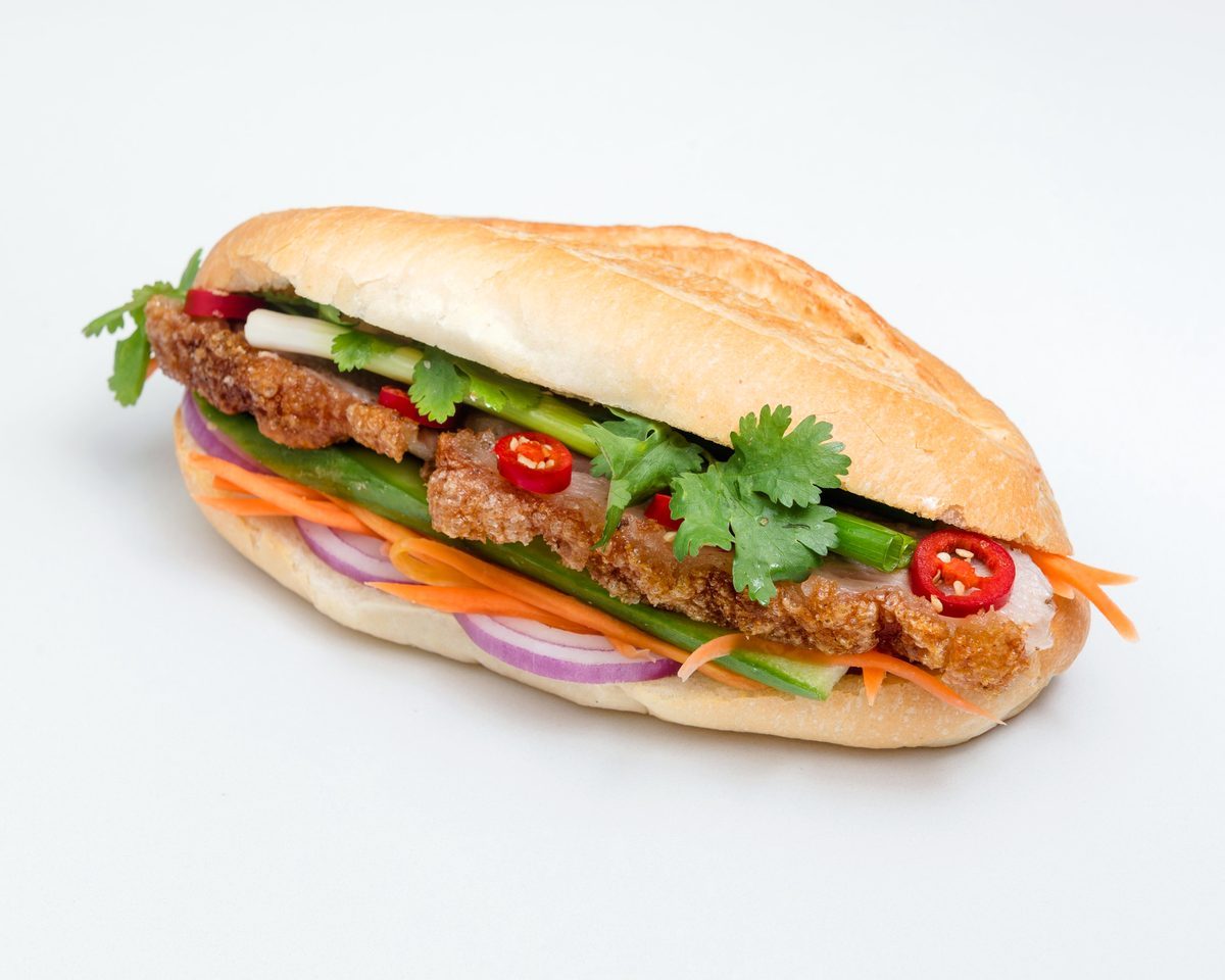 Roast pork roll with crackling, cucumber, pickled carrot and radish, red onion, coriander and chilli